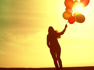 Woman with Baloons at Sunset