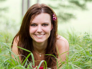 Happy Woman in Grass on Stomach