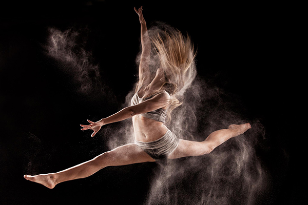 woman-jumping-and-dancing-in-a-cloud-of-powder