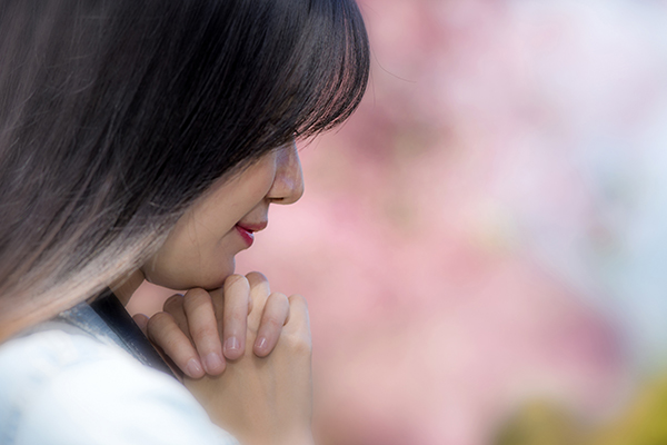 young beautiful woman praying