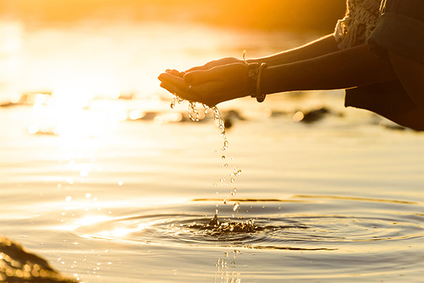 woman hands dropping water