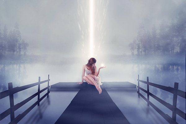 lonely woman sitting on pier with bright ball of glowing light in her hand