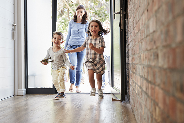 excited children arriving home with parents