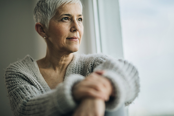 Portrait of beautiful mature woman relaxing by the window.