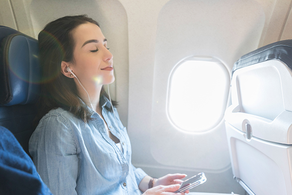 Young woman relaxes during flight