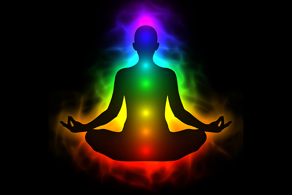 Human energy body with aura and chakras in meditation