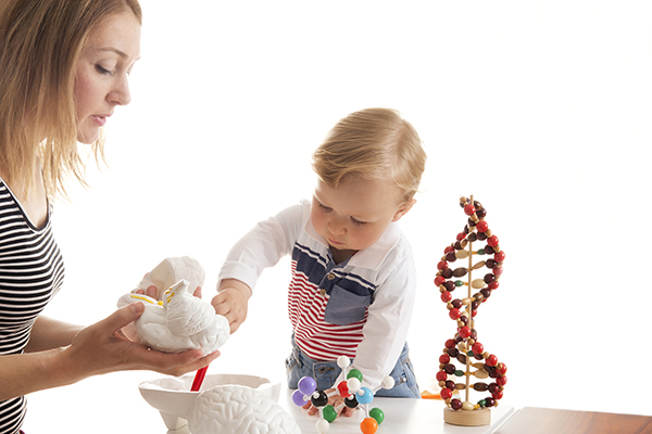 Mother and son playing with scientific models