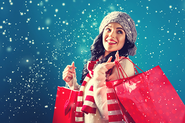 Happy young woman holding shopping bags