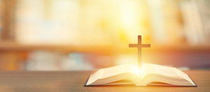 Christian wooden cross on open bible, Holy concept