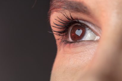 Female eye macro shot on iris is visible heart shape